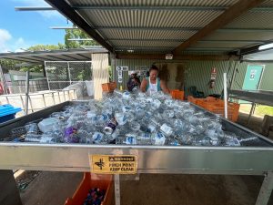 A Crystal Ailan worker sorts returned plastic containers for recycling