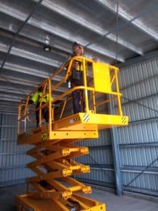 Pride of Place Trainees operating a scissor lift